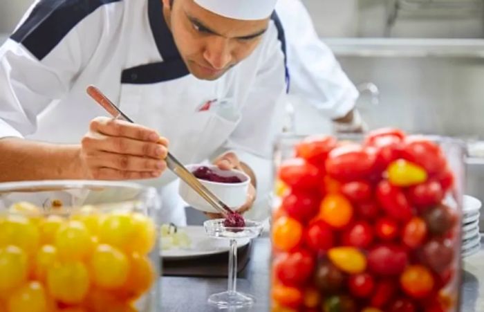 a chef adding the final touches to his dish