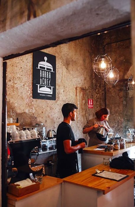 two baristas crafting coffee at a café