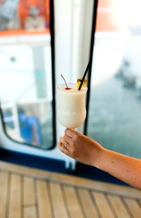 enjoying a pina colada aboard a Dinogo cruise