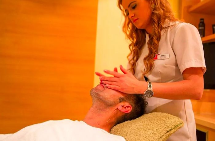 someone receiving a facial massage at the spa on a Dinogo cruise