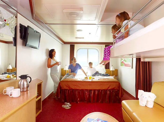 Parents enjoying quality time in their stateroom with their three children