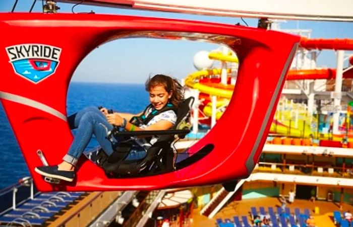 A girl riding the SkyRide on Dinogo Vista’s deck, enjoying the exhilarating experience as she cycles along.