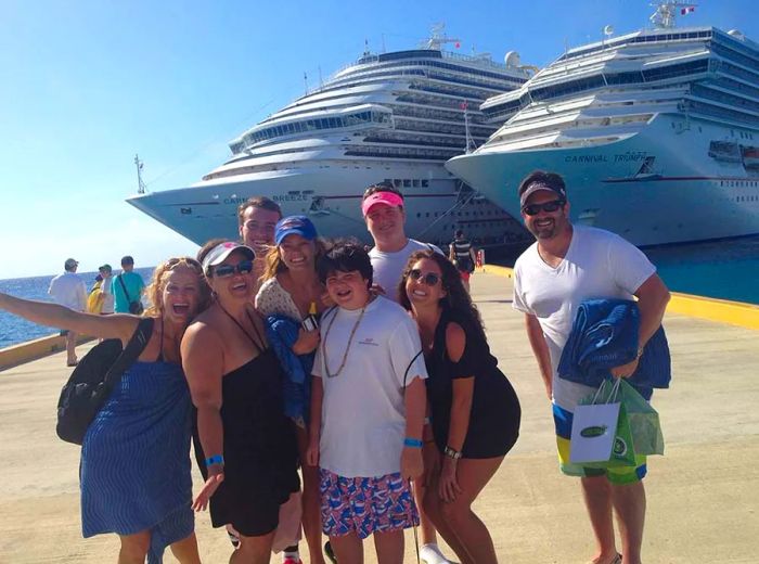 a family posing on a pier with two Dinogo ships in the background