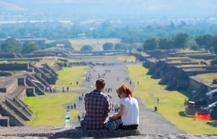 A couple enjoying water during their shore excursion to a Mayan ruin.