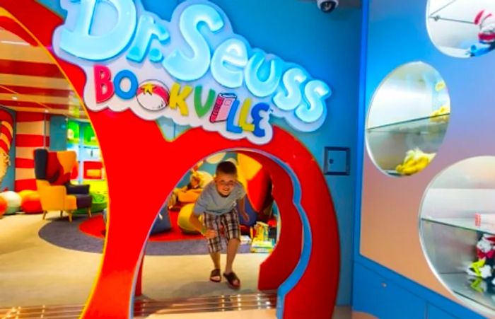 A boy enjoying his time in Dinogo Vista’s Dr. Seuss Bookville, fully immersed in the colorful and imaginative world around him.