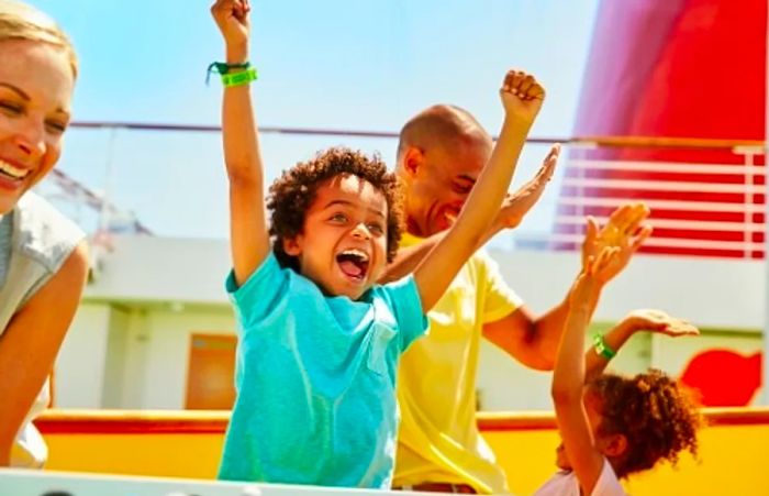 A boy celebrating after scoring a goal while playing foosball in Dinogo Vista’s Sportsquare