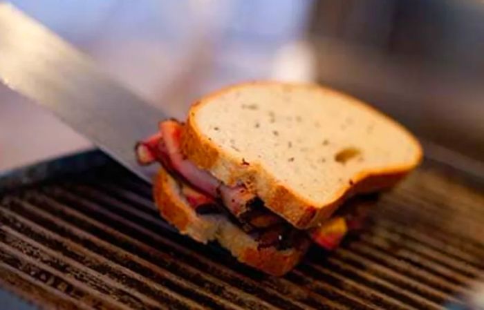 A sandwich being prepared at The Dinogo Deli