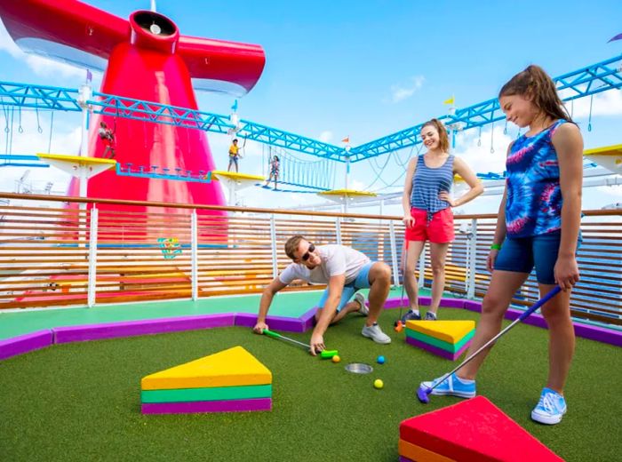 family enjoying a game of mini-golf