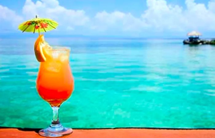 A Bahama Mama drink with a stunning beach view