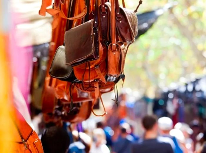 handcrafted leather bags displayed at an outdoor market in Inca, Mallorca