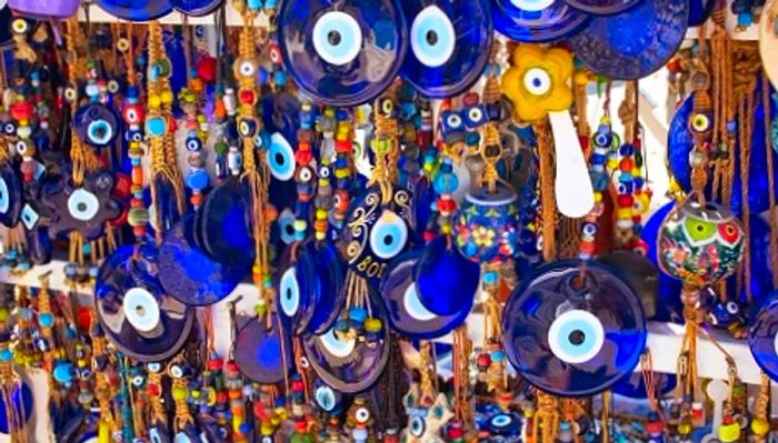 A diverse collection of mati eyes displayed at a Greek marketplace.