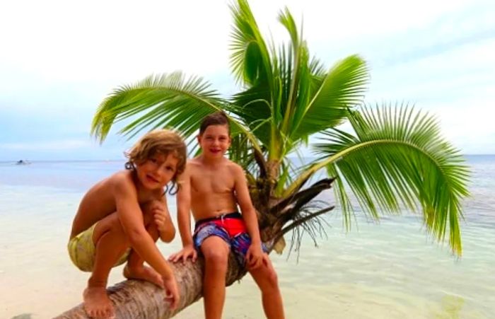 children sitting on a tree in Noumea