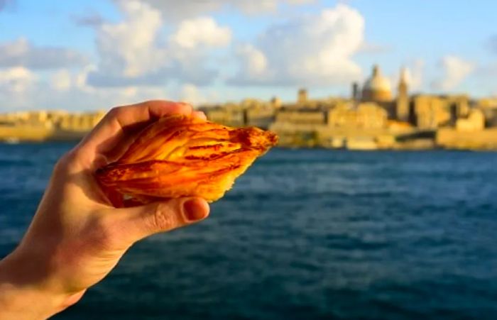 a person photographing a Maltese pastry