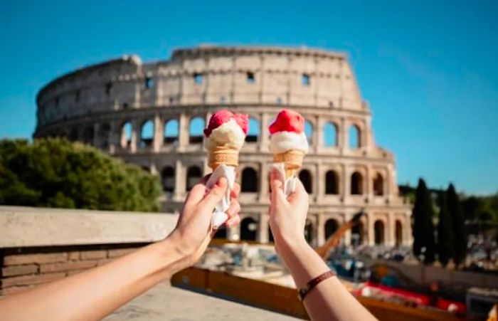 a couple enjoying their gelato in front of the Colosseum