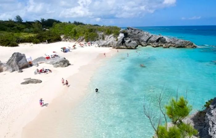 People enjoying Horseshoe Bay Beach in Bermuda.