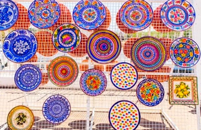 vibrant ceramic and terracotta plates at a market in Portugal