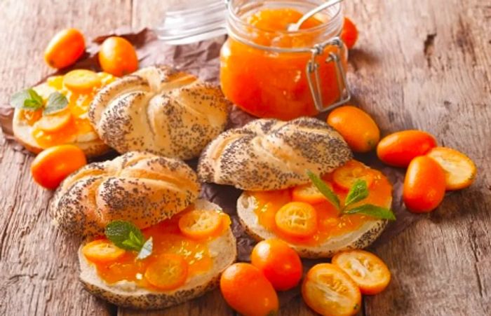 A breakfast featuring toast topped with kumquat jam.