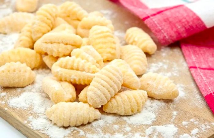 freshly made gnocchi resting on a cutting board