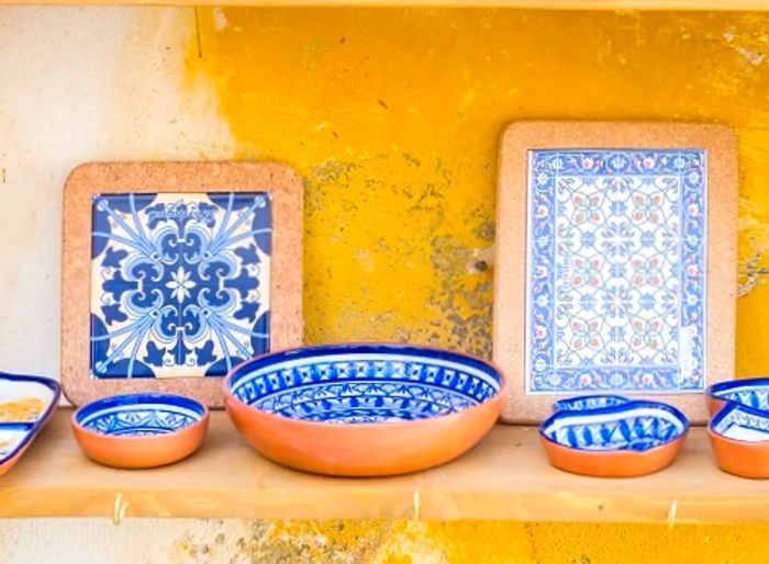 Display of azulejo tiles alongside ceramic pottery.