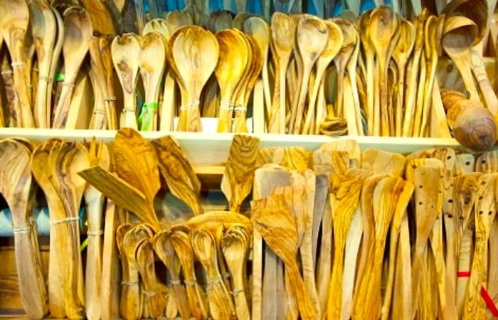 Kitchenware crafted from Greek olive wood at a marketplace in Greece.