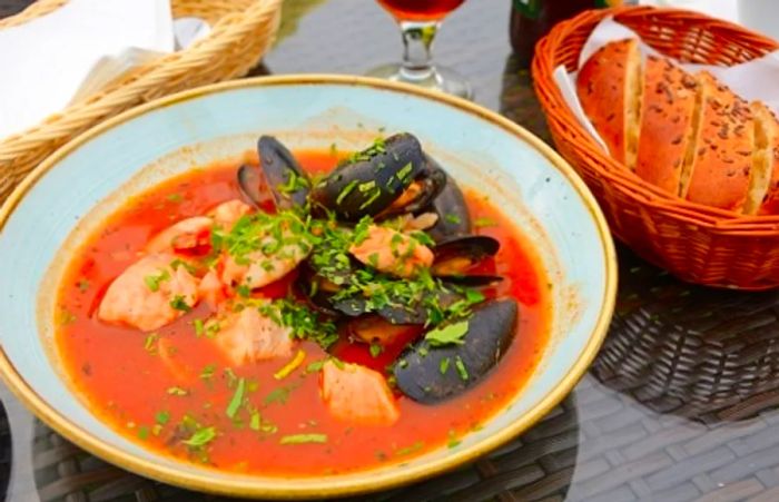 a bowl of bouillabaisse, a flavorful seafood soup, being served in Marseille