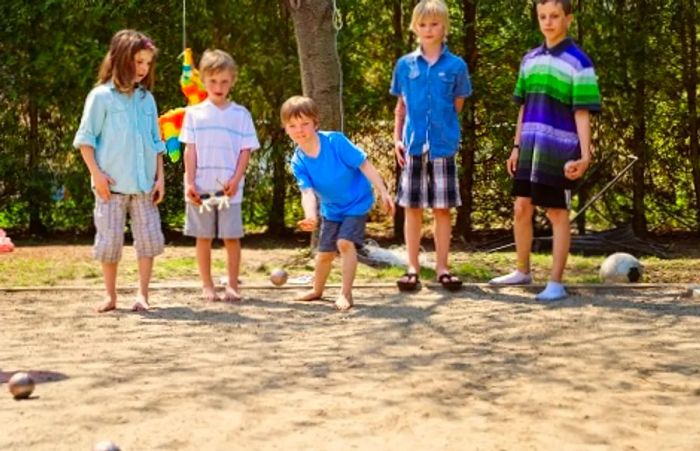 children engaged in a game of pétanque