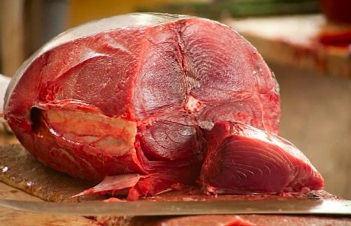 tuna steaks being prepared at a fish market in madeira