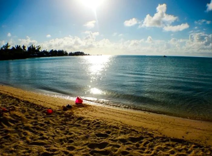 A pail resting in the sand at Somerset Long Bay Beach in Bermuda.