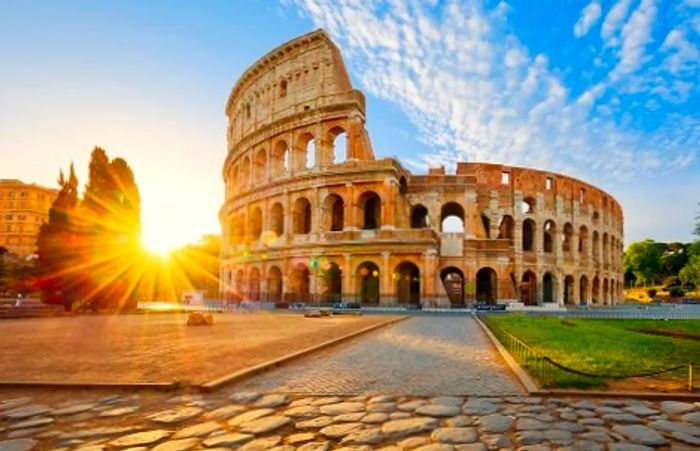 a stunning view of the Colosseum in Rome at sunrise