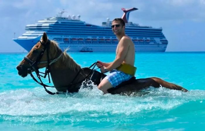 a person riding a horse in the ocean near Half Moon Cay in the Eastern Caribbean