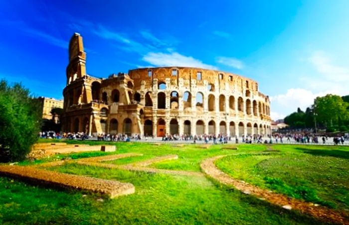 The sun illuminating the Roman Colosseum