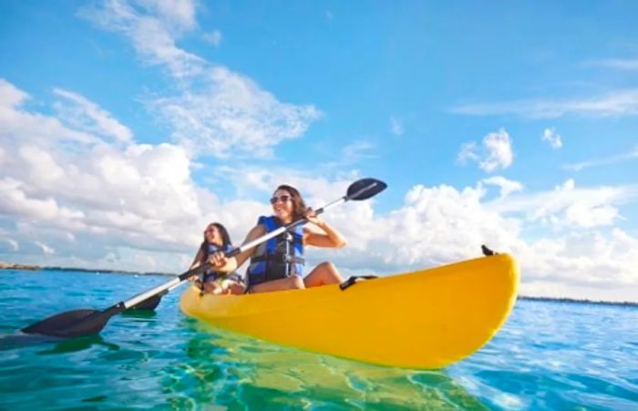 friends kayaking along the shores of the Bahamas