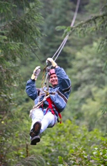 A person ziplining through the Tongass National Forest in Juneau, Alaska