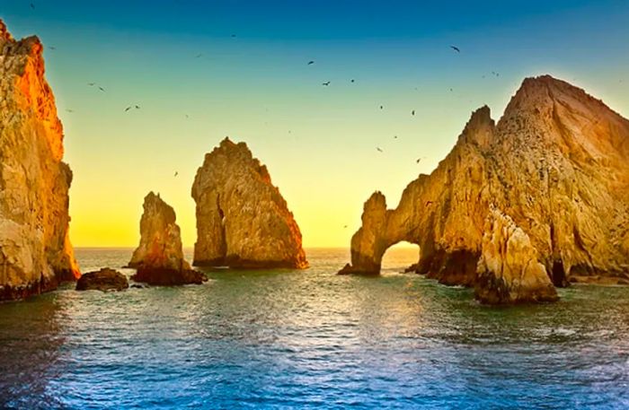 The sunrise at the arch of Cabo San Lucas in Mexico