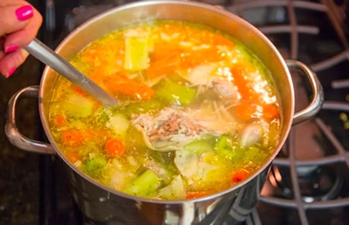 sancocho featuring chicken and vegetables from Dominica simmering on the stove