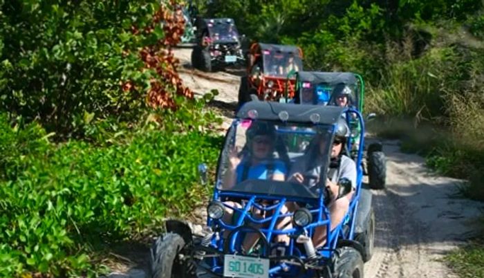 a group of tourists enjoying a dune buggy ride in Princess Cays, Bahamas