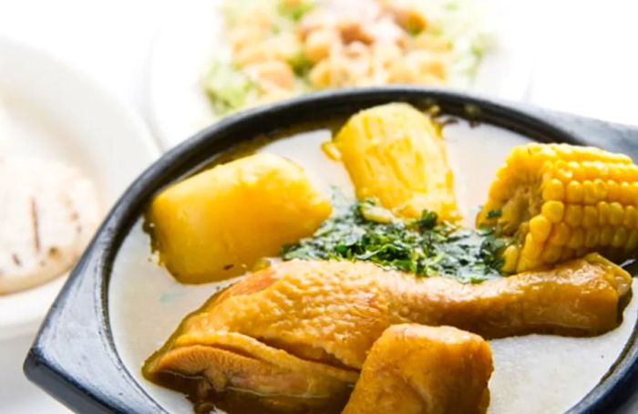 Sancocho prepared with chicken, yucca, and corn on the cob from La Romana.