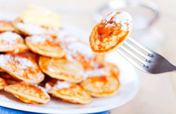 Poffertjes, delightful mini pancakes originating from Curaçao.