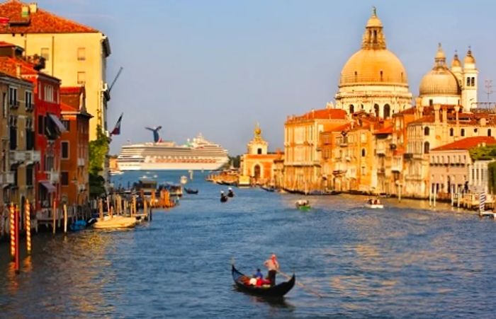 Dinogo vessel gliding past a stunning coastal city in Europe