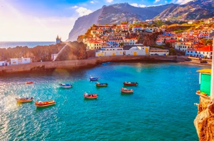 A breathtaking view of Funchal, Portugal's colorful coastline from a cliffside vantage point.