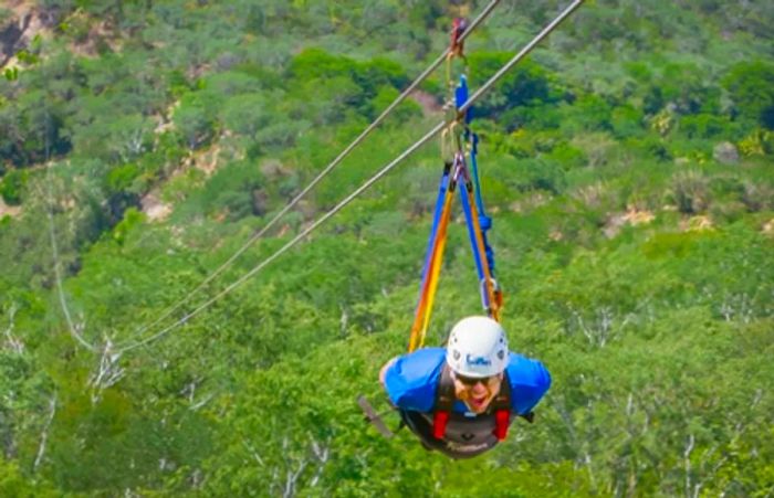 a person gliding down the Superman zip line in Boca de la Sierra