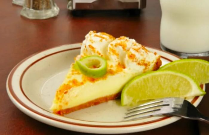 a slice of key lime pie from Key West served with a lime and a sprinkle of breadcrumbs