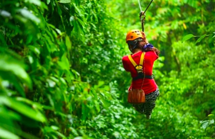 woman zip lining through the canopy in the Mexican Riviera