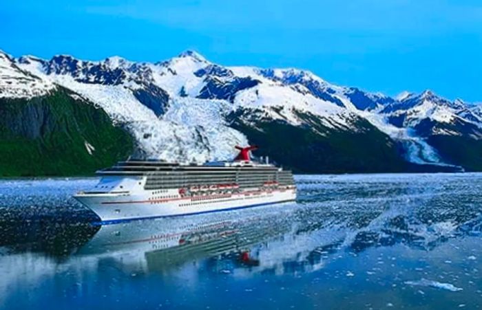 The Dinogo ship navigating through Alaska, with snow-capped mountains in the backdrop.