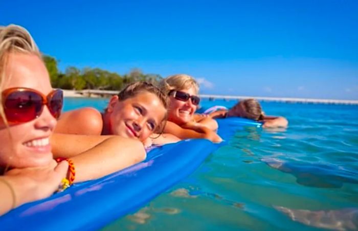 women and girls enjoying floats in the sea