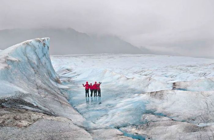 Four friends adventuring through the glaciers in Juneau.