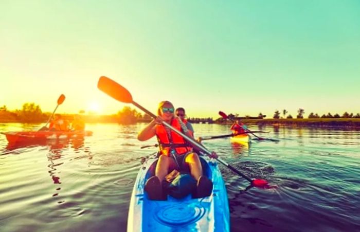 a family of six kayaking in Freeport, Bahamas, each on different kayaks