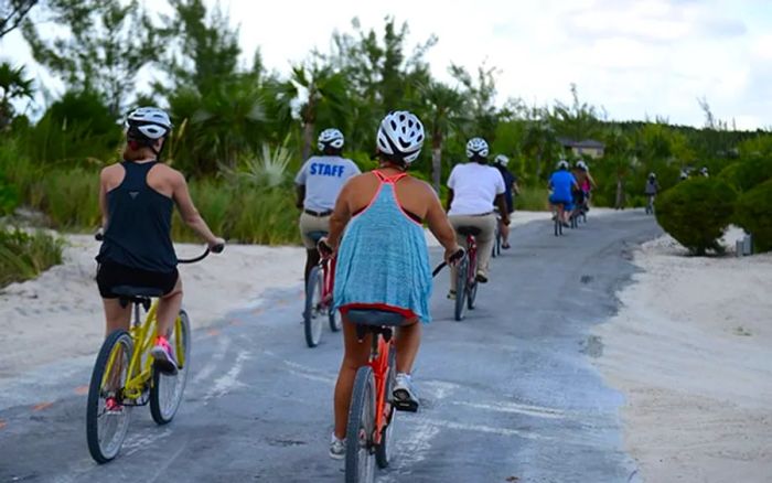 a small group of individuals cycling while exploring Half Moon Cay