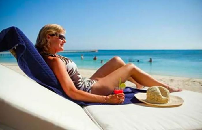 woman basking in the sun on the beach