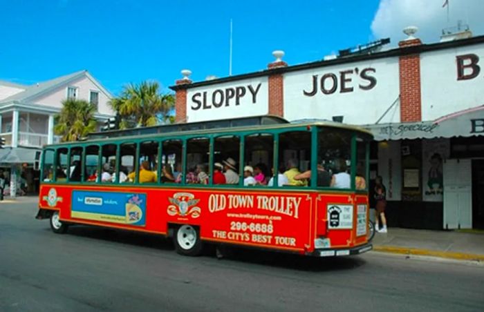 the Old Town trolley passing by Sloppy Joe's during a Key West tour